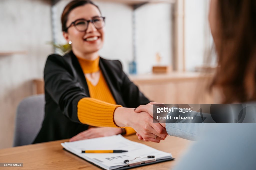 Young Woman Meeting With A Real Estate Agent