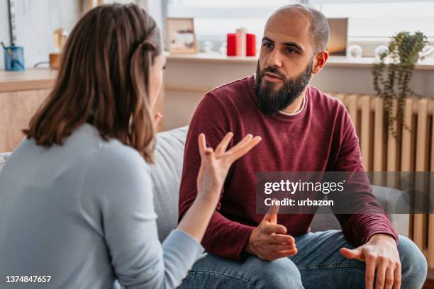 young couple arguing at home - pouting stock pictures, royalty-free photos & images