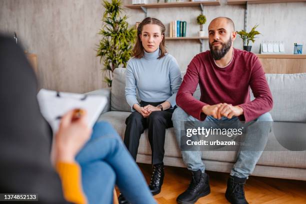 young couple going to marriage counseling - young couple talking stock pictures, royalty-free photos & images