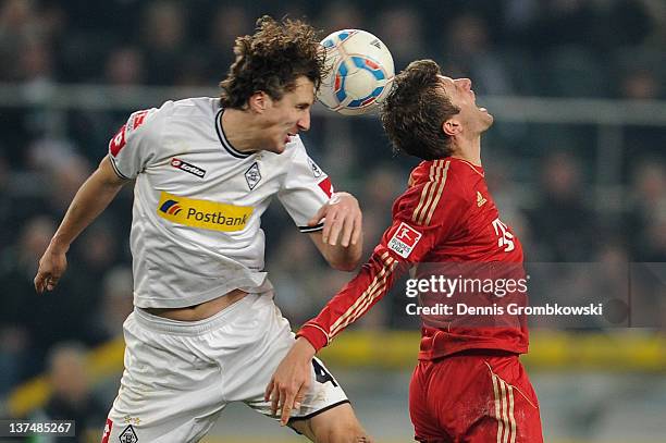 Roel Brouwers of Moenchengladbach and Thomas Mueller of Bayern jump for a header during the Bundesliga match between Borussia Moenchengladbach and FC...