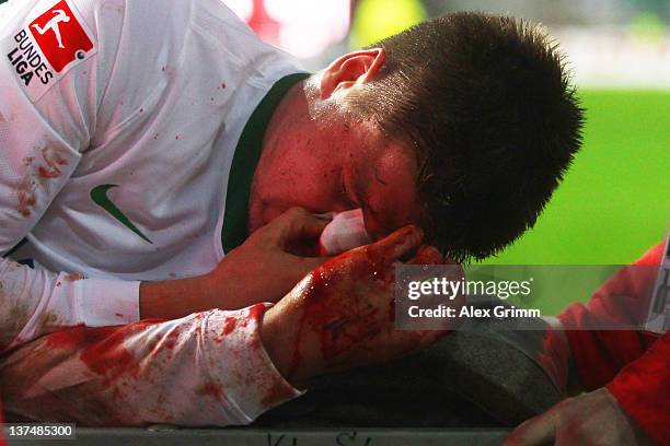 Sebastian Proedl of Bremen is carried off on a stretcher during the Bundesliga match between 1. FC Kaiserslautern and SV Werder Bremen at...