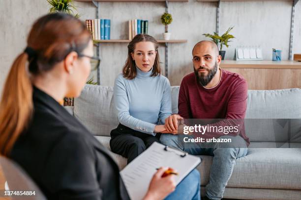 young couple going to marriage counseling - empathetic listening stock pictures, royalty-free photos & images