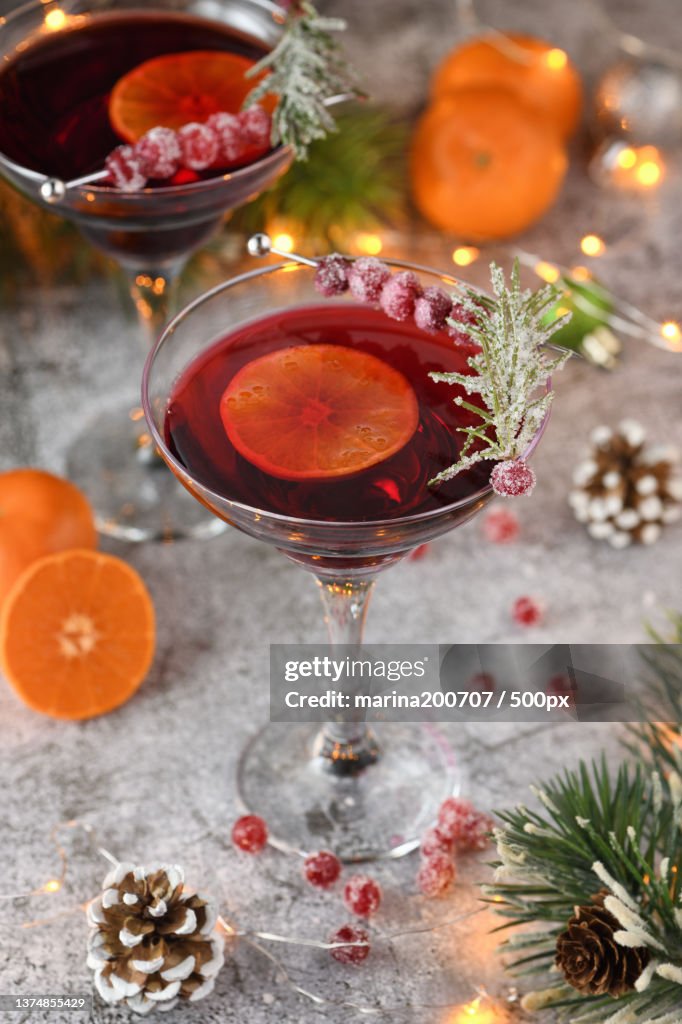 High angle view of cranberry margaritas with wine and christmas decorations on table