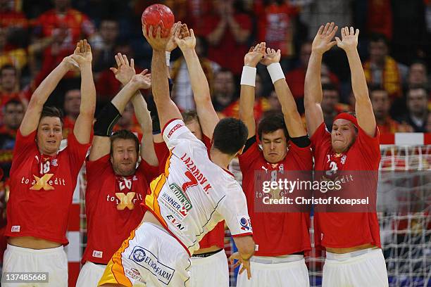 Kiril Lazarov of Macedonia throws against the wall of Denmark during the Men's European Handball Championship second round group one match between...