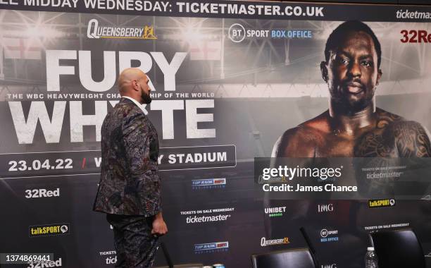 Tyson Fury faces on with a picture of Dilian Whyte during the Tyson Fury v Dillian Whyte press conference at Wembley Stadium on March 01, 2022 in...