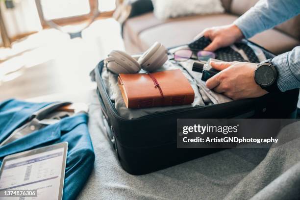 packing for a business trip. - business class imagens e fotografias de stock