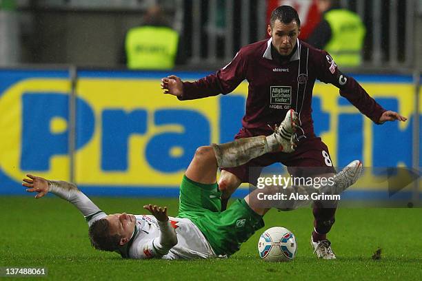 Philipp Bargfrede of Bremen is challenged by Christian Tiffert of Kaiserslautern during the Bundesliga match between 1. FC Kaiserslautern and SV...