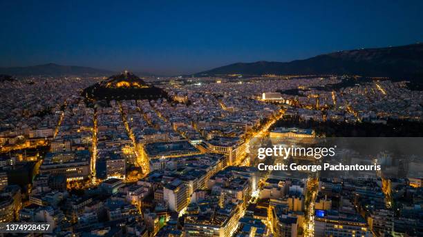 aerial photo of downtown athens, greece and the greek parliament at night - syntagma square stock pictures, royalty-free photos & images