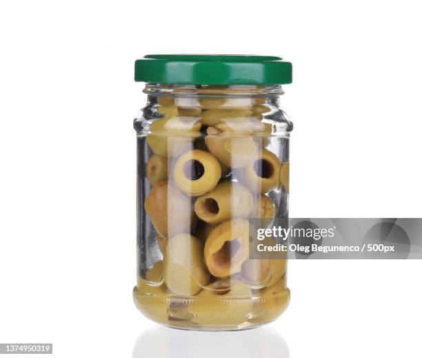 glass with green olives,close-up of food in jar against white background,moldova - canned food on white stock pictures, royalty-free photos & images