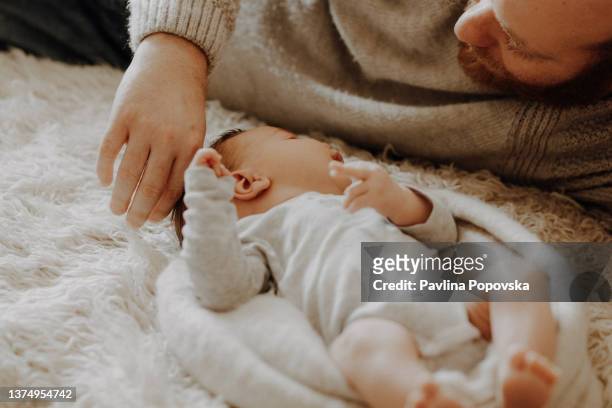 father looking at his newborn sun - photo shoot at home stock pictures, royalty-free photos & images