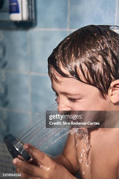 close up of young child singing in the shower - ducha stock pictures, royalty-free photos & images