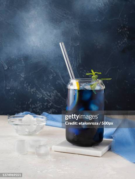 cold blue tea in a transparent glass with ice cubes,russia - tea glass table bildbanksfoton och bilder