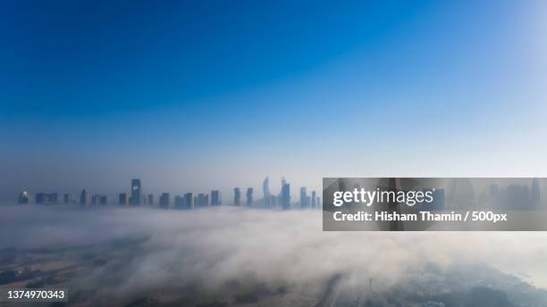 lusail skyline under fog,aerial view of shanghai lujiazui financial district in fog,doha,qatar - doha skyscraper stock pictures, royalty-free photos & images