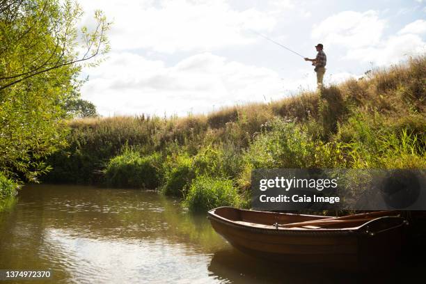 336 Man Holding Fishing Pole Stock Photos, High-Res Pictures, and