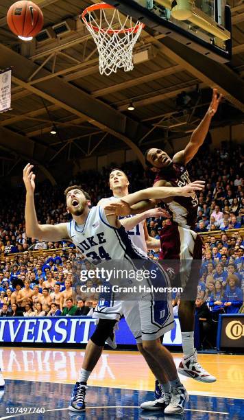 Ryan Kelly and Mason Plumlee of the Duke Blue Devils fight for position with Michael Snaer of the Florida State Seminoles as they battle for a...