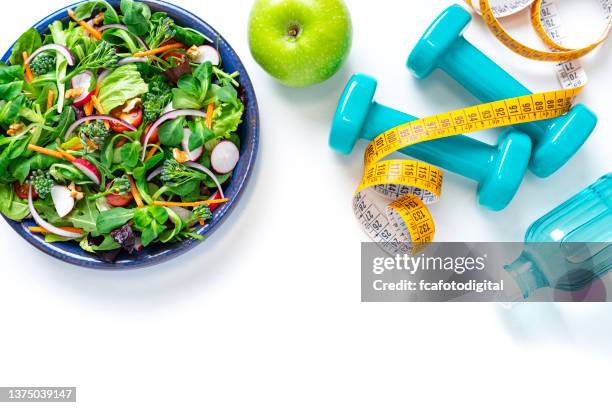 healthy eating and exercising. copy space on white background - centimeter stockfoto's en -beelden