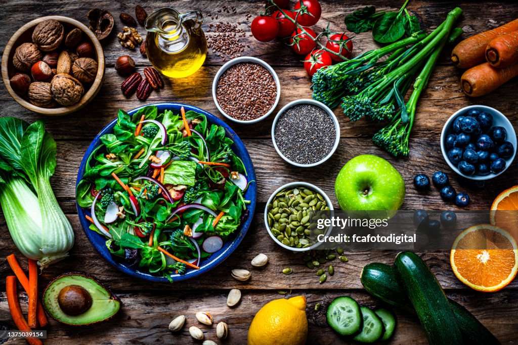 Healthy fruits and vegetables salad plate on rustic table