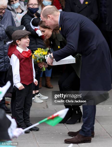 Catherine, Duchess of Cambridge and Prince William, Duke of Cambridge meet children during a visit to Abergavenny Market with Prince William, Duke of...