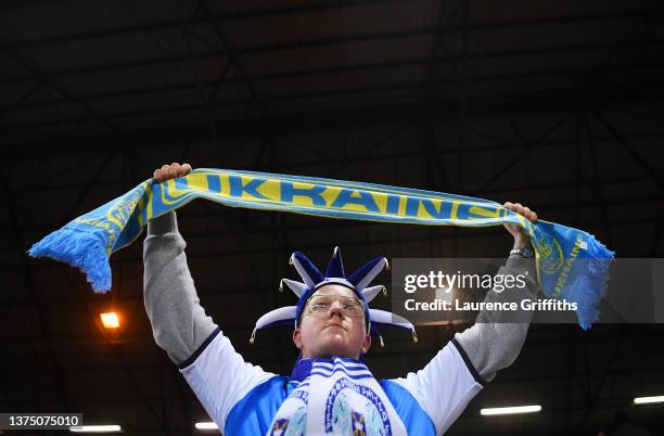 Peterborough United fan holds a Ukrainian scarf to indicate peace and sympathy with Ukraine prior to the Emirates FA Cup Fifth Round match between...