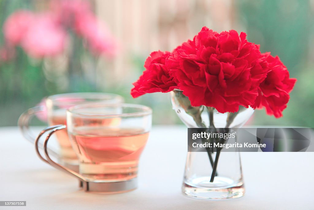 Tea with carnation flowers