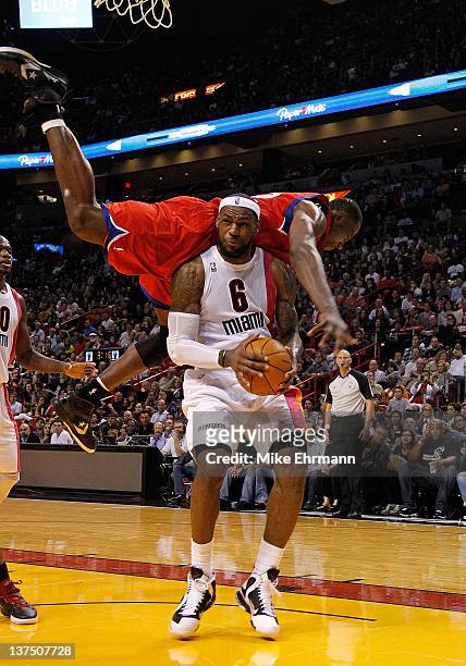 Elton Brand of the Philadelphia 76ers fouls LeBron James of the Miami Heat during a game at American Airlines Arena on January 21, 2012 in Miami,...