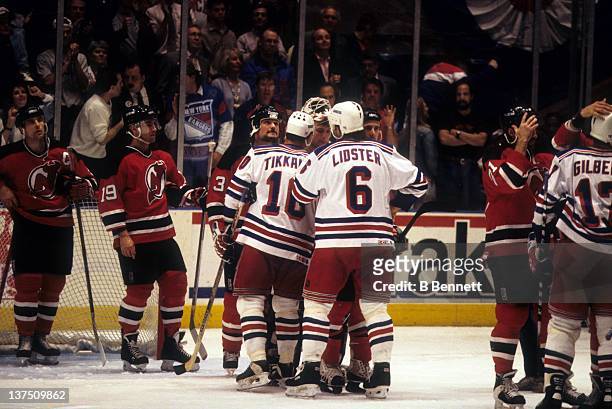 Esa Tikkanen and Doug Lidster of the New York Rangers shake hands with goalie Martin Brodeur of the New Jersey Devils after the Rangers defeated the...