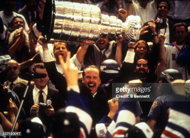 Head coach Mike Keenan of the New York Rangers celebrates with the Stanley Cup after the Rangers defeated the Vancouver Canucks in Game 7 of the 1994...