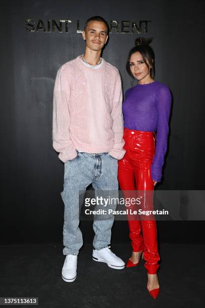 Romeo Beckham and Victoria Beckham attend the Saint-Laurent Womenswear Fall/Winter 2022/2023 show as part of Paris Fashion Week on March 01, 2022 in...