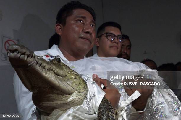 Victor Hugo Sosa, Mayor of San Pedro Huamelula, holds a spectacled caiman called "La Niña Princesa" before marrying her in San Pedro Huamelula,...