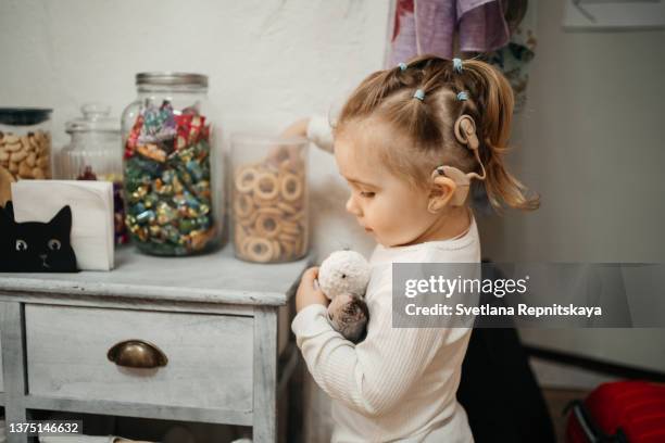 baby with cochlear implants having fun. - cochlea implant stock pictures, royalty-free photos & images