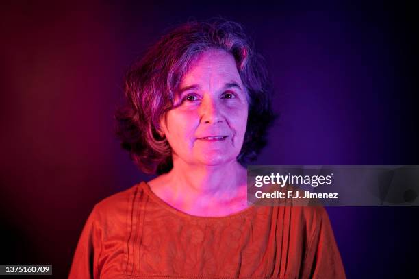 portrait of mature woman with blue and red lighting - illuminated portrait stock pictures, royalty-free photos & images