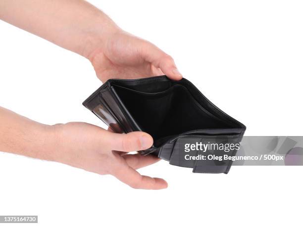 black empty purse in hand,cropped hands of woman holding empty wallet against white background,moldova - empty wallet stock pictures, royalty-free photos & images