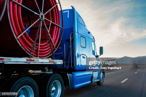 semi trucks on a four lane highway near the ivanpah solar power facility - convoy of traffic stock pictures, royalty-free photos & images