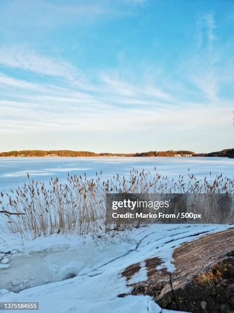 scenic view of frozen lake against sky - frozen lake stock pictures, royalty-free photos & images