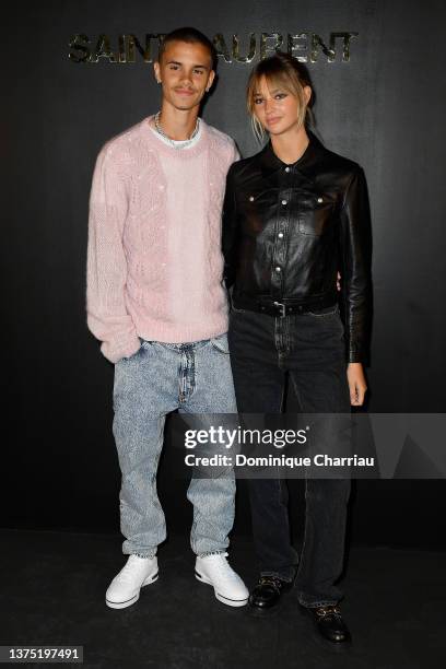 Romeo Beckham and Mia Regan attend the Saint-Laurent Womenswear Fall/Winter 2022/2023 show as part of Paris Fashion Week on March 01, 2022 in Paris,...