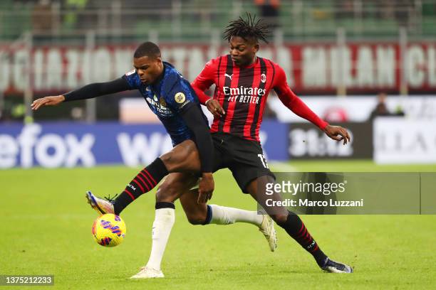 Denzel Dumfries of FC Internazionale battles for possession with Rafael Leao of AC Milan during the Coppa Italia Semi Final 1st Leg match between AC...