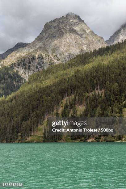 lago di anterselva,scenic view of lake by mountains against sky,anterselva di sopra,bolzano,italy - bolzano stock pictures, royalty-free photos & images