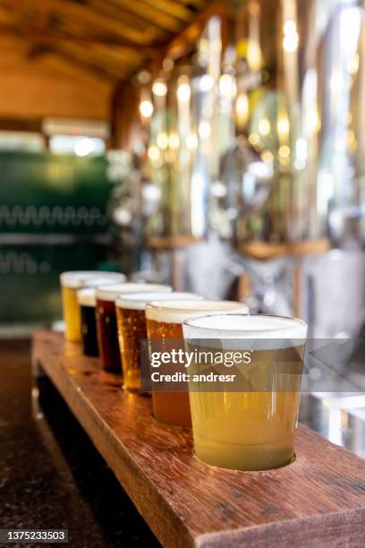 close-up on samples of beer at a brewery - brewing stock pictures, royalty-free photos & images