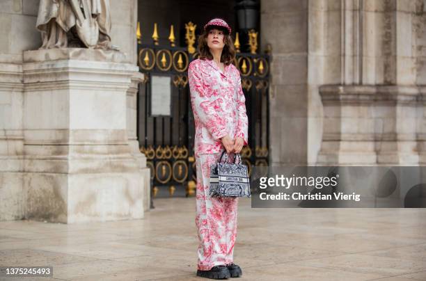 Lea Naumann seen wearing Dior visor cap in red, Dior button shirt, pants, Dior bag, black shoes outside Nanushka during Paris Fashion Week -...