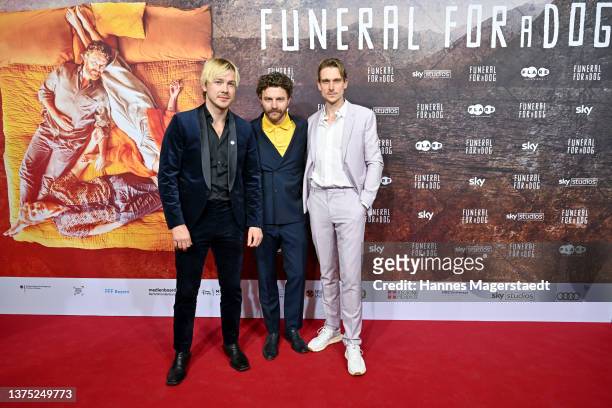 Albrecht Schuch, Friedrich Mücke and Daniel Sträßer attend the premiere of "Funeral for a Dog" at Gloria Palast on March 01, 2022 in Munich, Germany.