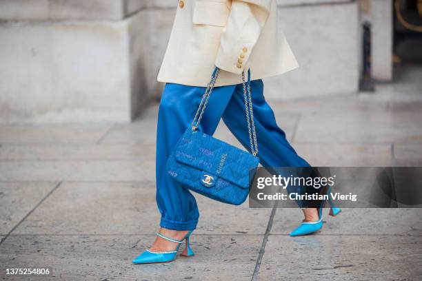 Grece Ghanem seen wearing latte beige blazer, blue silk pants, blue Chanel bag, turquoise heels, sunglasses outside Nanushka during Paris Fashion...