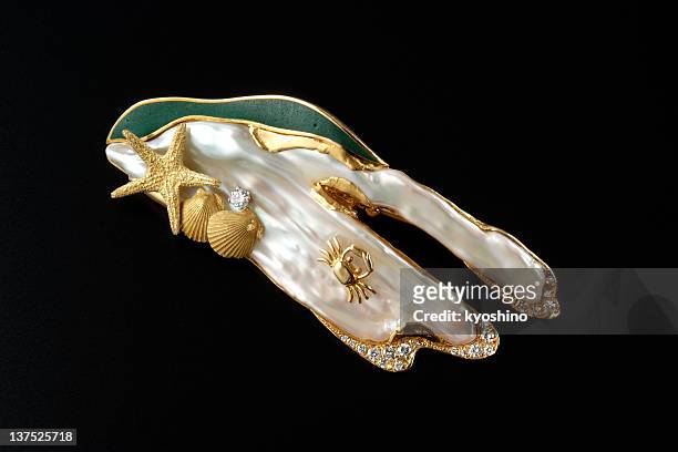 isolated shot of luxury gold brooch on black background - vintage brooch stock pictures, royalty-free photos & images