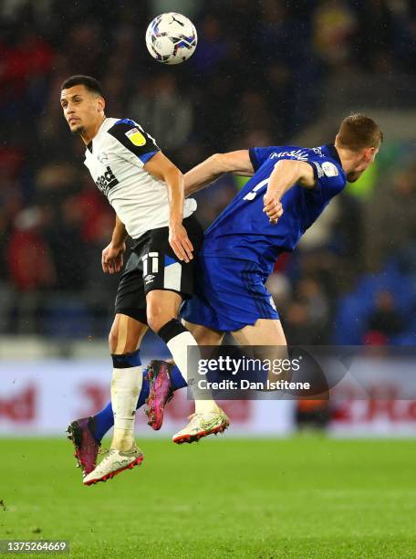 Ravel Morrison of Derby County challenges for the high ball with Mark McGuinness of Cardiff City during the Sky Bet Championship match between...