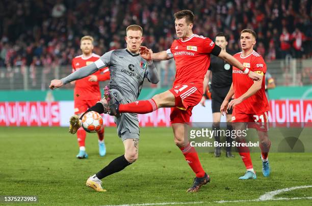 Simon Makienok of St Pauli battles for possession with Robin Knoche of 1.FC Union Berlin during the DFB Cup quarter final match between 1. FC Union...