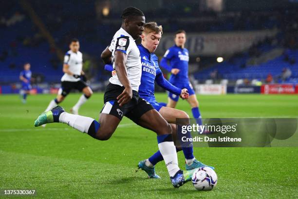 Festy Ebosele of Derby County controls the ball under pressure from Joel Bagan of Cardiff City during the Sky Bet Championship match between Cardiff...