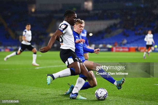Festy Ebosele of Derby County controls the ball under pressure from Joel Bagan of Cardiff City during the Sky Bet Championship match between Cardiff...