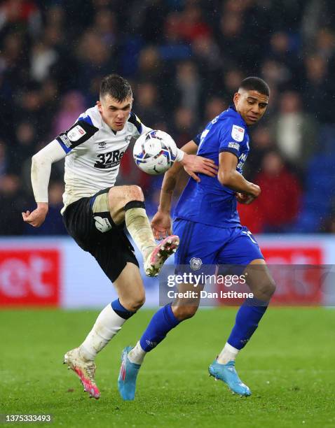 Jason Knight of Derby County battles for the ball with Cody Drameh of Cardiff City during the Sky Bet Championship match between Cardiff City and...