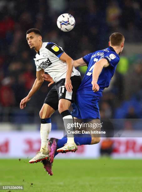 Ravel Morrison of Derby County jumps for the ball with Mark McGuinness of Cardiff City during the Sky Bet Championship match between Cardiff City and...