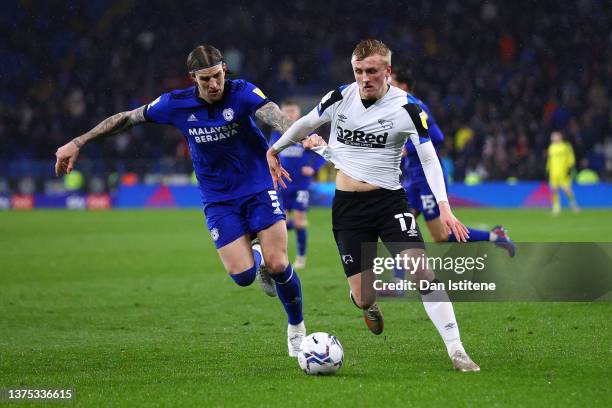 Louie Sibley of Derby County battles for the ball with Aden Flint of Cardiff City during the Sky Bet Championship match between Cardiff City and...