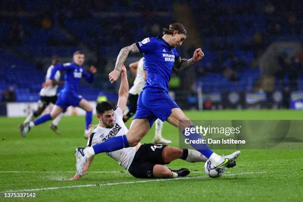 Eiran Cashin of Derby County battles for the ball with Aden Flint of Cardiff City during the Sky Bet Championship match between Cardiff City and...